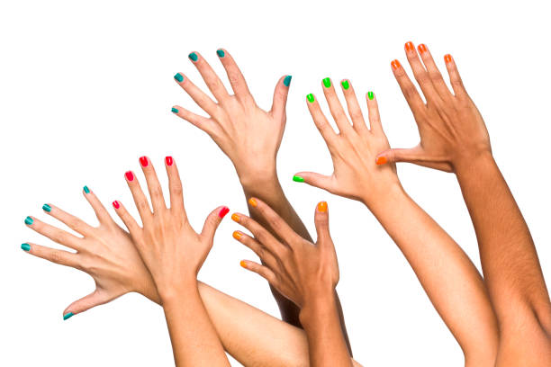 Hand with pink nails of white woman under black surface.
