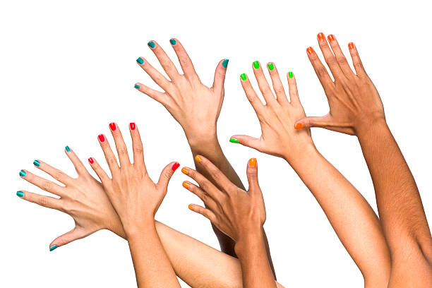 grupo de elevado multiethnics fêmea mãos com manicure de cores - hand raised arms raised multi ethnic group human hand imagens e fotografias de stock