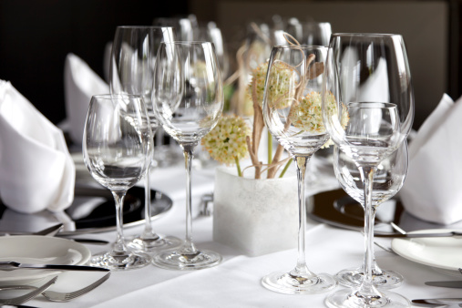 Restaurant table with wine glasses and napkins