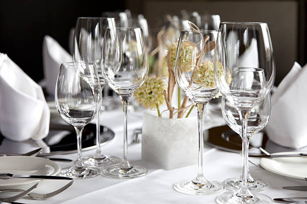 Restaurant table with wine glasses and napkins stock photo