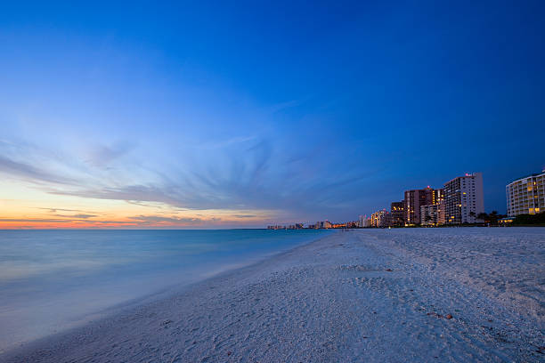 spiaggia di sabbia bianca del resort al tramonto - naples florida foto e immagini stock