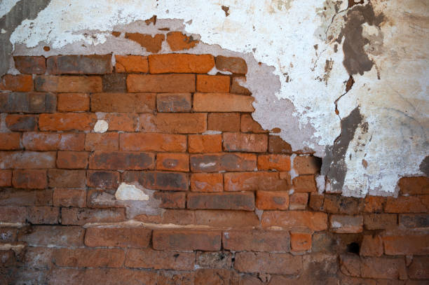 istock Background of old vintage dirty brick wall with peeling plaster, texture,reddish clayey material, hard when dry, forming topsoil in some tropical or subtropical regions and sometimes used for building 1656182083