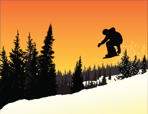 Snowboarder in mid-air at sunset.