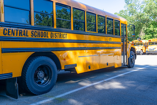 Side of a parked yellow school district bus