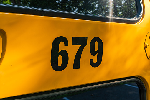 Side of a parked yellow school bus number 679