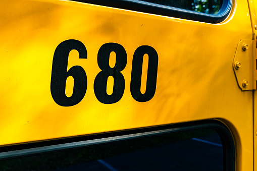 Back of a parked yellow school bus number 680