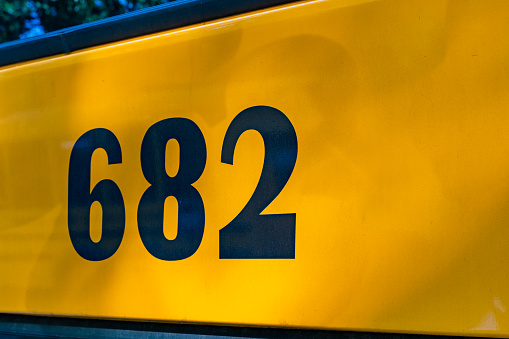 back of a parked yellow school bus number 682