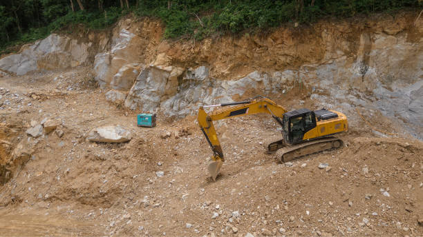 istock backhoe excavator. Old dirty yellow rock excavator stopped working 1656263335
