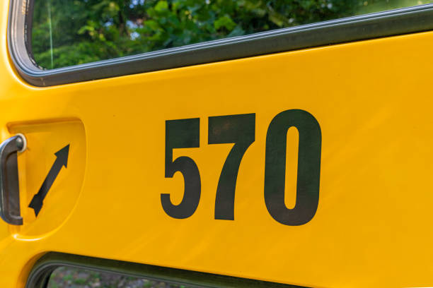 istock Back of a parked yellow school bus number 570 1656280664