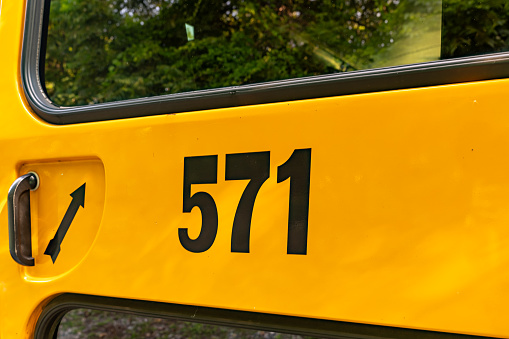 Back of a parked yellow school bus number 671
