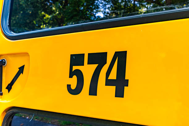 istock Back of a parked yellow school bus number 574 1656281727