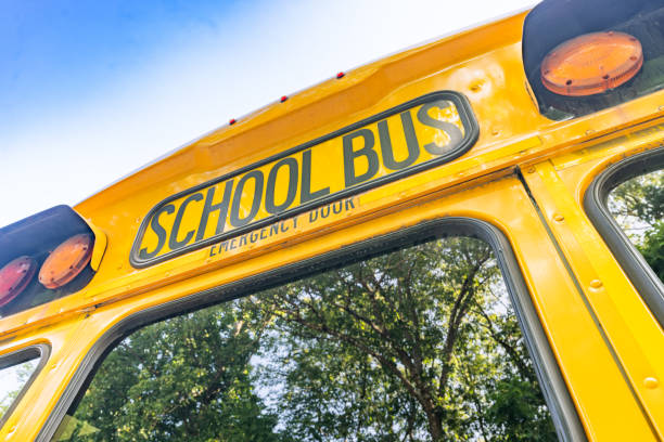 istock rear of a parked yellow school bus 1656281756