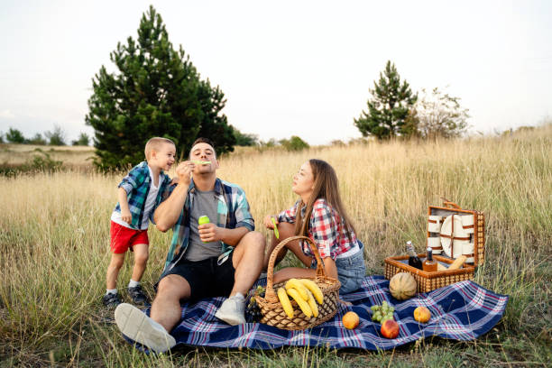 istock Family with one child blowing bubbles on a picnic 1656289644