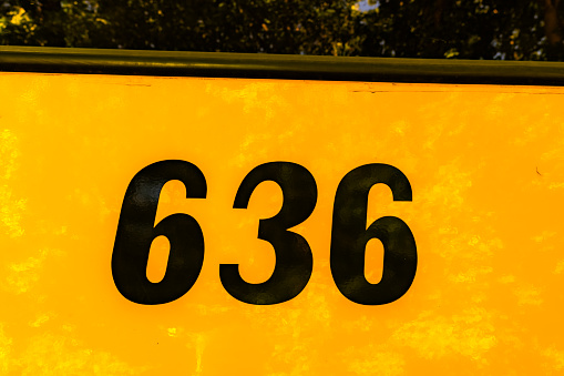 Front of a parked yellow school bus number 636