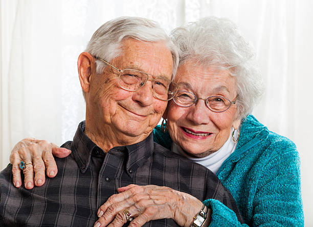 istock married senior couple togetherness, embracing, smiling at camera 165629363