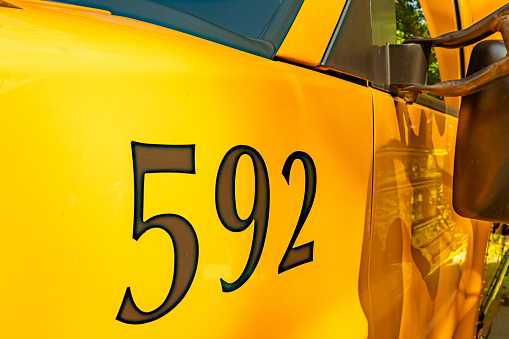 Side of a parked yellow school bus number 592