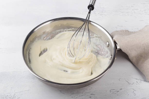 istock Making cheese sauce for pasta. Add milk and mix until creamy. DIY step by step step 6 1656300576