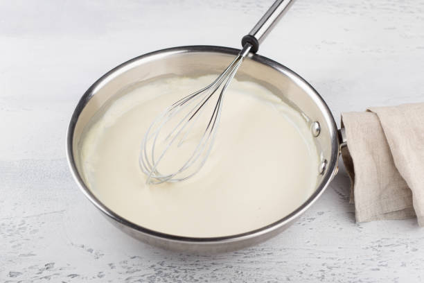 istock Making cheese sauce for pasta. Add milk and mix until creamy. DIY step by step step 7 1656300601