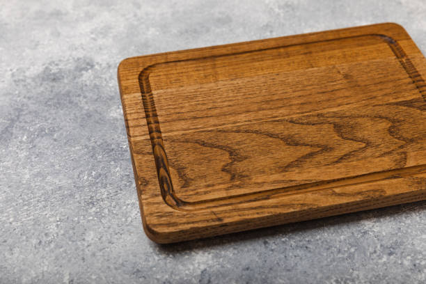 istock Cutting board on a textured marble kitchen table. Menu food card or recipes background concept.MOCKUP. Design. Place for text, copy space. The concept of food and cooking. 1656390406