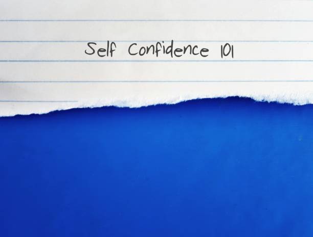 istock Torn lined note paper with text written SELF CONFIDENCE 101 , on blue background with copy space. Concept of learning to build self confidence for the success of life and career 1656392528