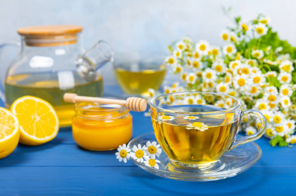 istock Chamomile tea in a  cup on a  texture background. Natural hour with chamomile flowers. Herbal tea. Immunity tea.Natural healer concept. Healthy detox drink.Close up. Place for text. 1656411178