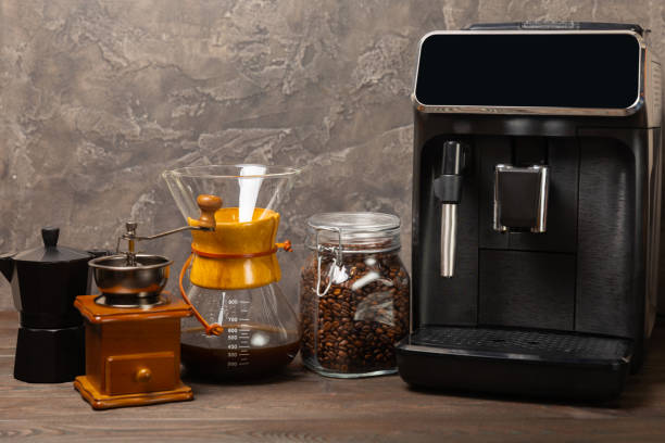 istock Modern coffee machine with a cup on the kitchen table. Coffee house. Modern espresso coffee machine with a cup in the kitchen. Preparation of a fragrant hot drink. Place for text.Copy space. 1656417085
