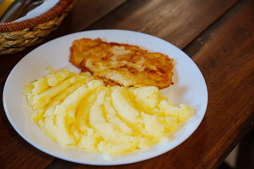 Plate with mashed potatoes and chop cutlet. close-up. A traditional homemade dish on the menu of the dining room.