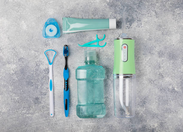 istock Electronic oral irrigator, toothbrush, paste, dental floss and mouthwash on a blue background. Dental tool for oral hygiene. Electric Interdental Cleaner. Dental water shower. Oral care concept. 1656423986