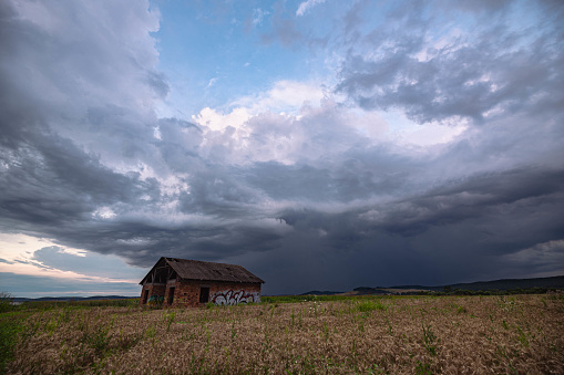 Curteni , Romania - July 30, 2023: Dramatic looking Cumulonimbus storm cloud over the countryside of Transylvania.