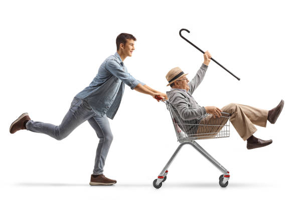istock Grandson pushing his grandfather inside a shopping cart 1656434619