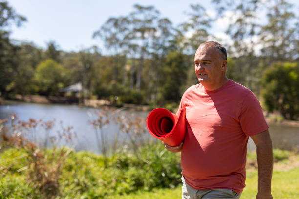istock Overweight middle aged man walking to yoga 1656435774