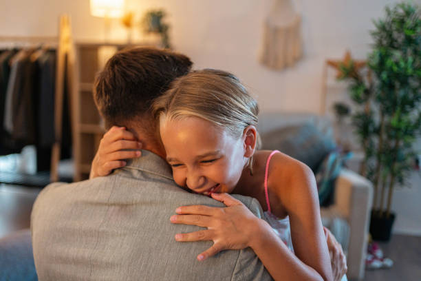 istock Daughter embracing her father, while he leaving late for a work 1656437789