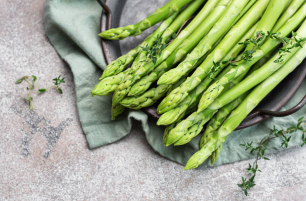 istock Fresh green asparagus on  concrete background. 1656448020