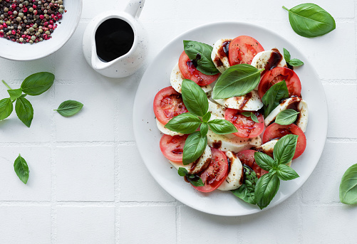 Caprese salad with tomatoes, mozzarella and basil. Healthy food.