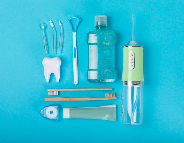 istock Electronic oral irrigator, toothbrush, paste, dental floss and mouthwash on a blue background. Dental tool for oral hygiene. Electric Interdental Cleaner. Dental water shower. Oral care concept. 1656448576