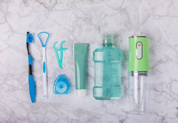 istock Electronic oral irrigator, toothbrush, paste, dental floss and mouthwash on a blue background. Dental tool for oral hygiene. Electric Interdental Cleaner. Dental water shower. Oral care concept. 1656448589