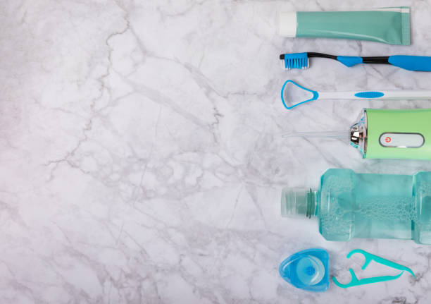 istock Electronic oral irrigator, toothbrush, paste, dental floss and mouthwash on a blue background. Dental tool for oral hygiene. Electric Interdental Cleaner. Dental water shower. Oral care concept. 1656448591
