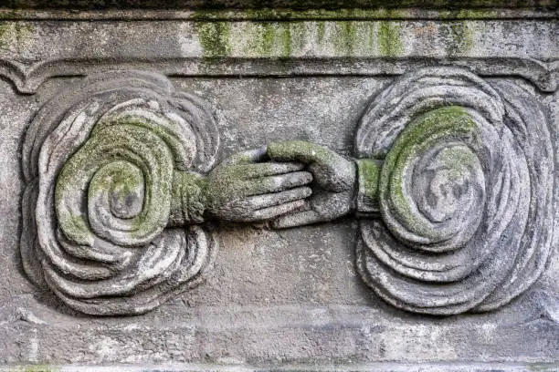 Photo of Hand of God handshake gravestone carving