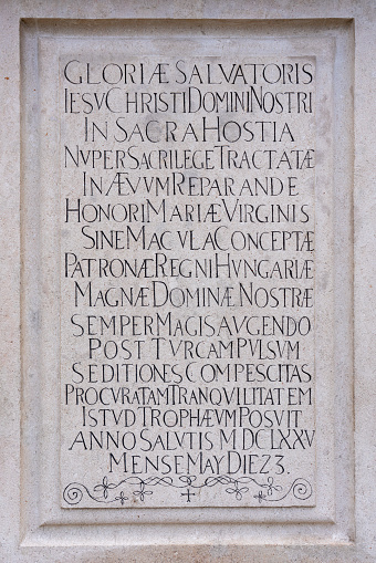 Long inscription engraved in stone in uppercase letters in Latin in late renaissance script, 17th century monument in Bratislava