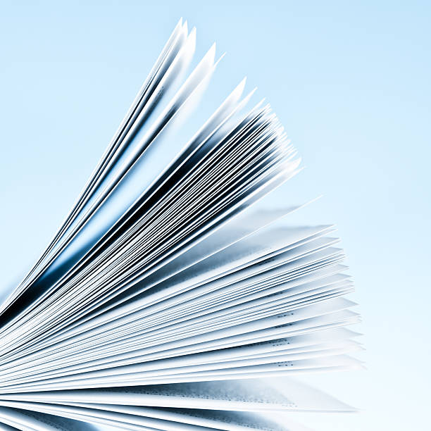 Close-up of magazine pages on light blue background stock photo