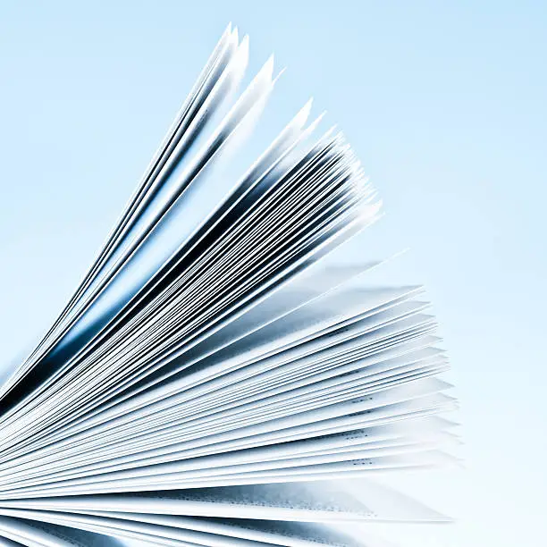 Photo of Close-up of magazine pages on light blue background