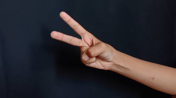 istock Element for peace symbol young woman hand on black background 1656470975