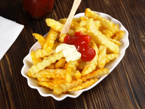 istock French Fries on wooden Background 1656473683