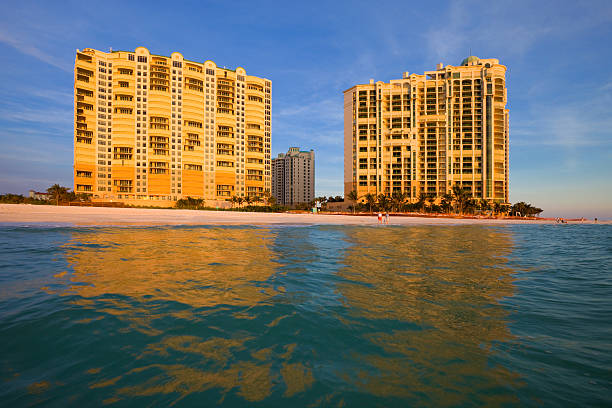 Resort at sunset, Marco Island, Florida, USA White sandy beach and tropical resort at sunset, Marco Island, Naples, Florida, USA marco island stock pictures, royalty-free photos & images