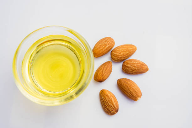 istock Almond oil with almond grains, white background 1656477542