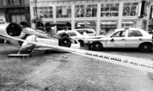 Cordon tape at crossroad between W.Randolph st and N.Dearborn st, Chicago, after car accident. Focus on Cordon tape.