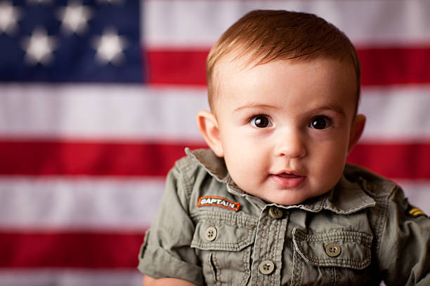 istock Happy Baby Boy in Camo by American Flag 165652302