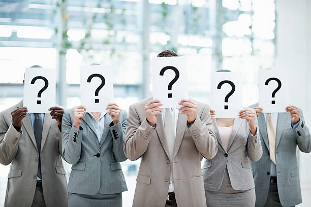 istock Business people holding sheet with question mark 165652447