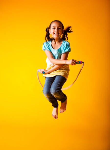 Cute Little Girl Jump Roping Cute little girl jump roping. jump rope stock pictures, royalty-free photos & images