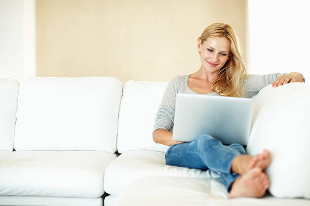 istock Pretty woman browsing on laptop 165652479